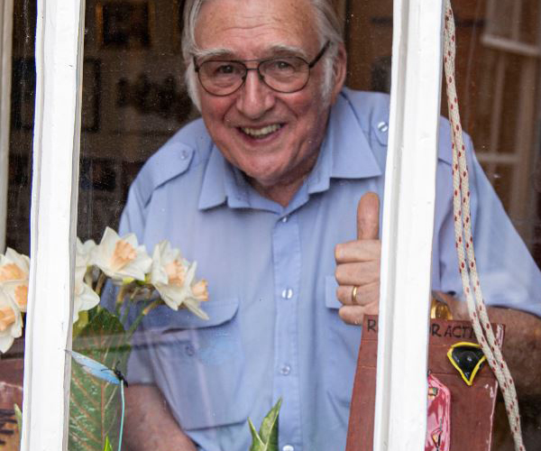 Pensioner Ray Pearson gives thumbs up from berth window